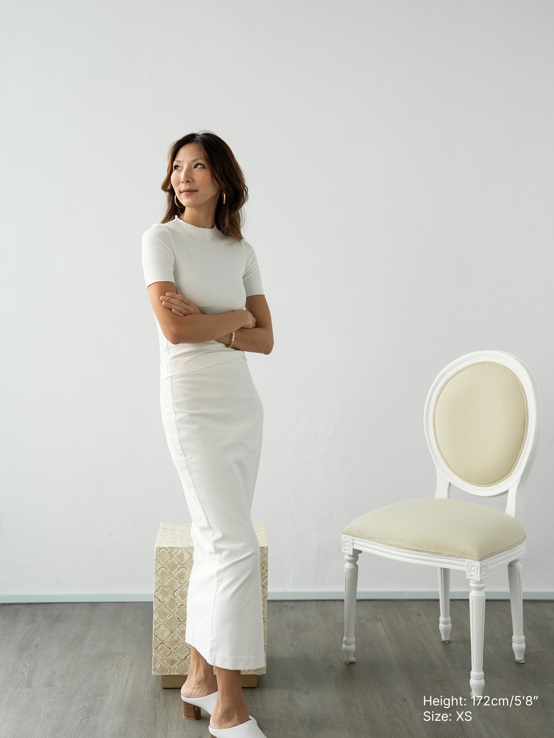 Woman wearing white knitted short sleeved top and white pants by Singapore women's fashion brand Hadasity.