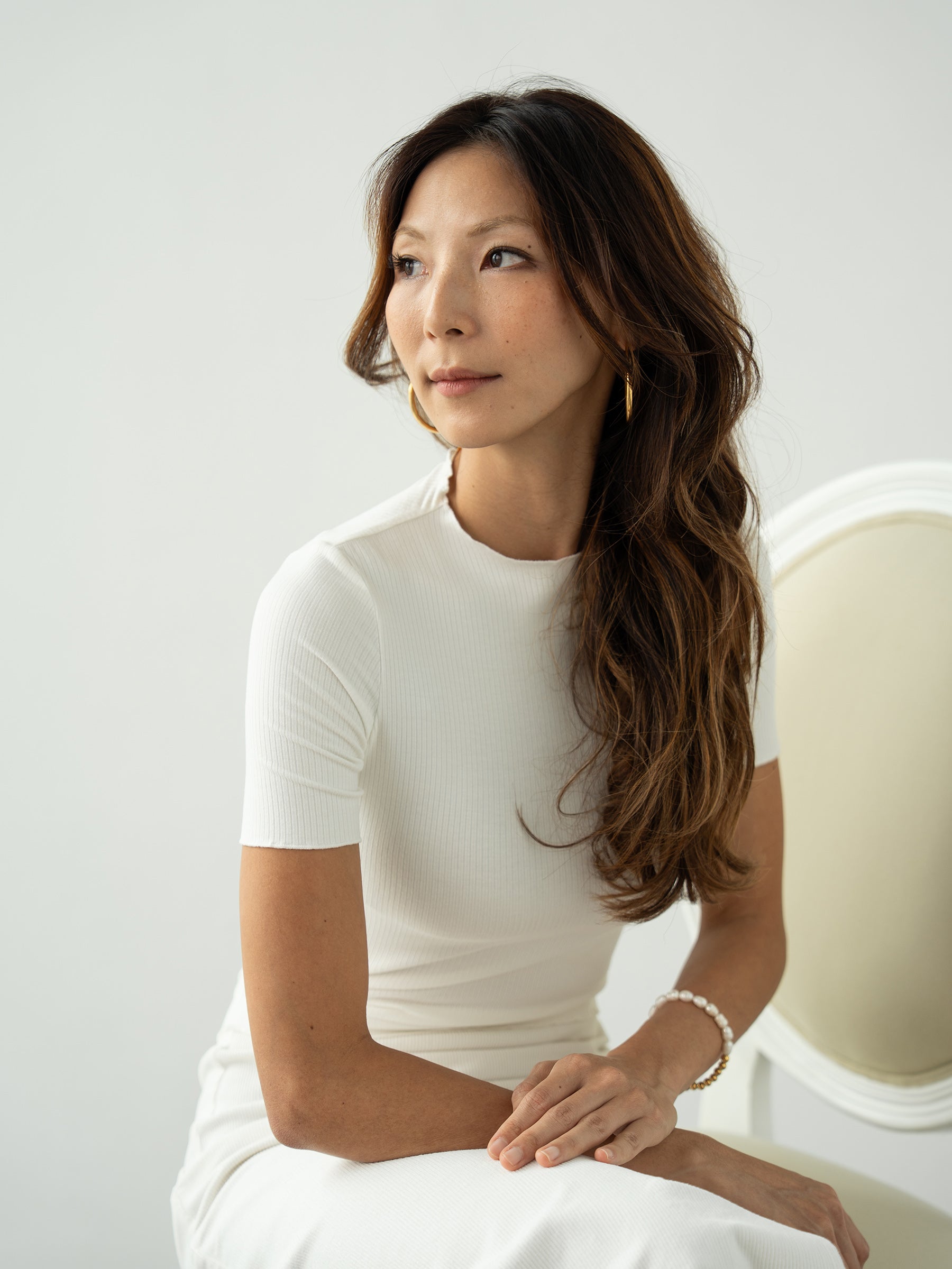 Woman wearing white knitted short sleeved top and white pants by Singapore women's fashion brand Hadasity.