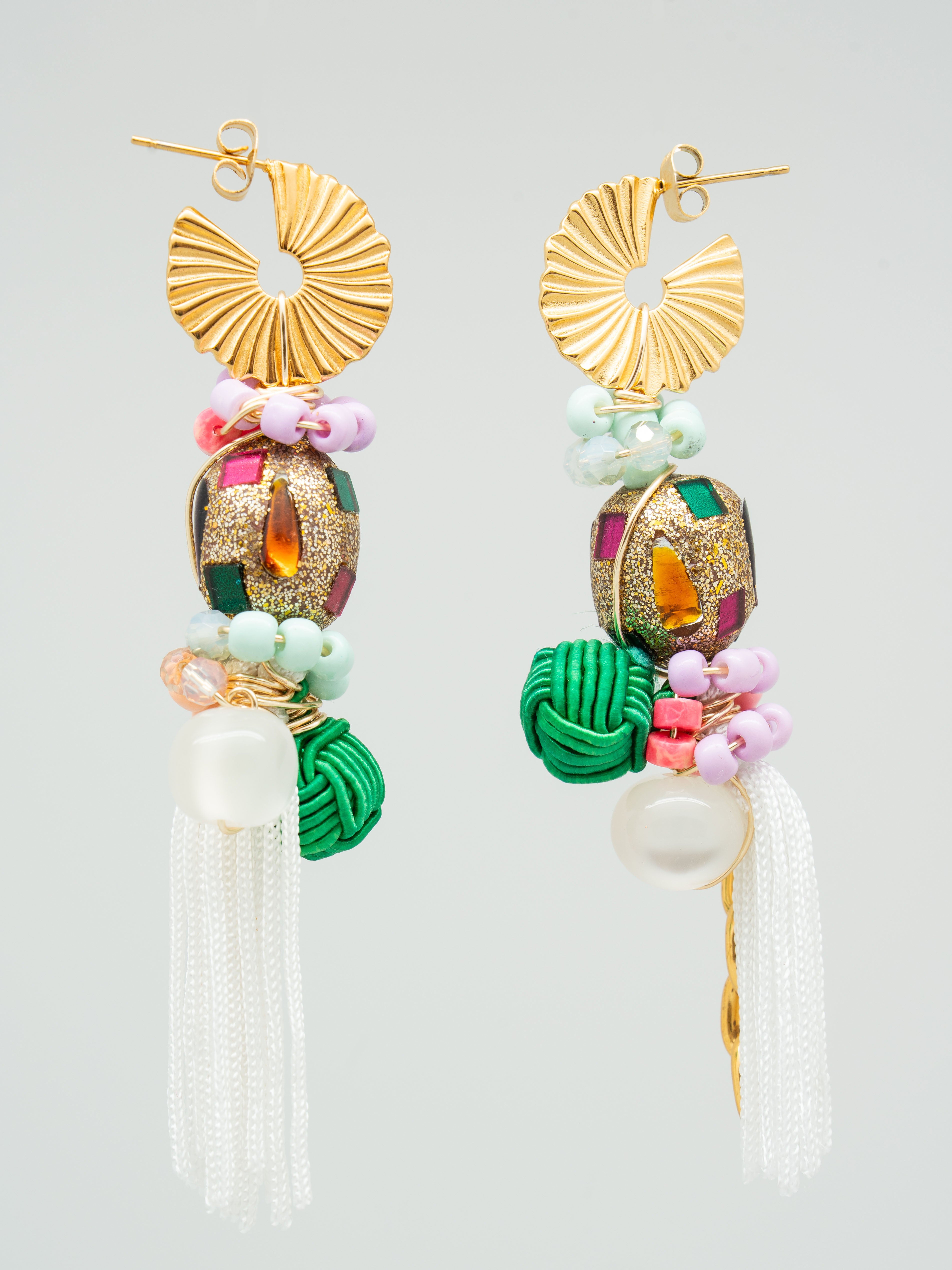 Colourful women's earrings with multicolour seed beads, swarovski crystals, gold chains, and white tassels.