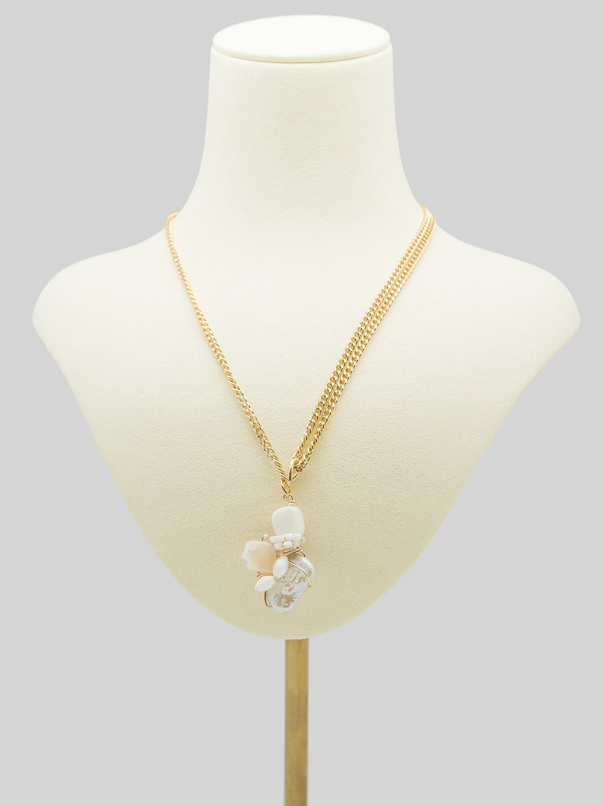 One of a kind necklace with freshwater pearl, white agate, and mother of pearl.