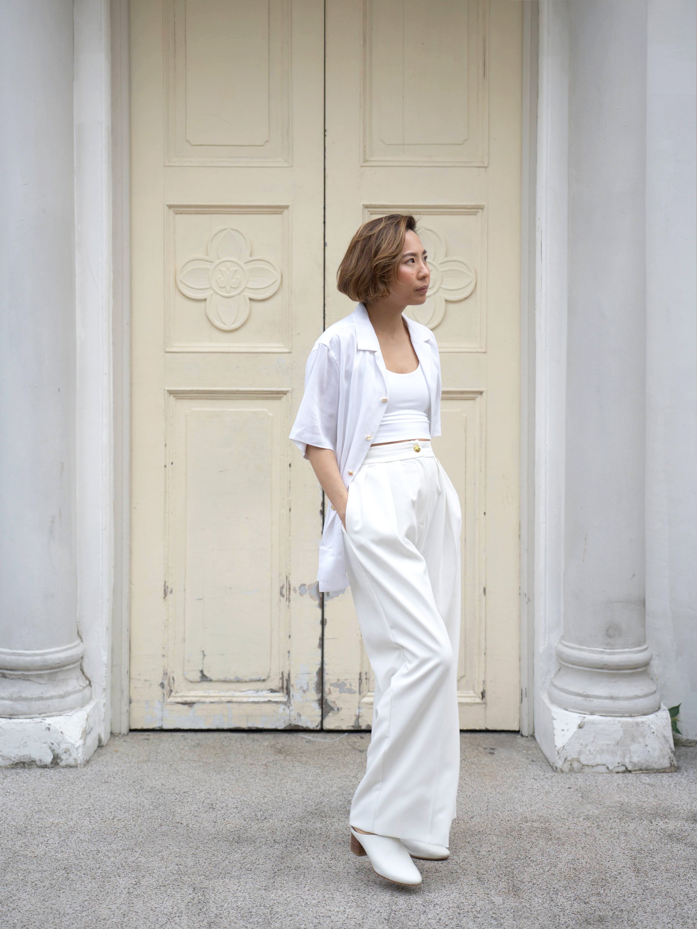 Woman wearing white linen top and white skirt by Singapore women's fashion brand Hadasity.