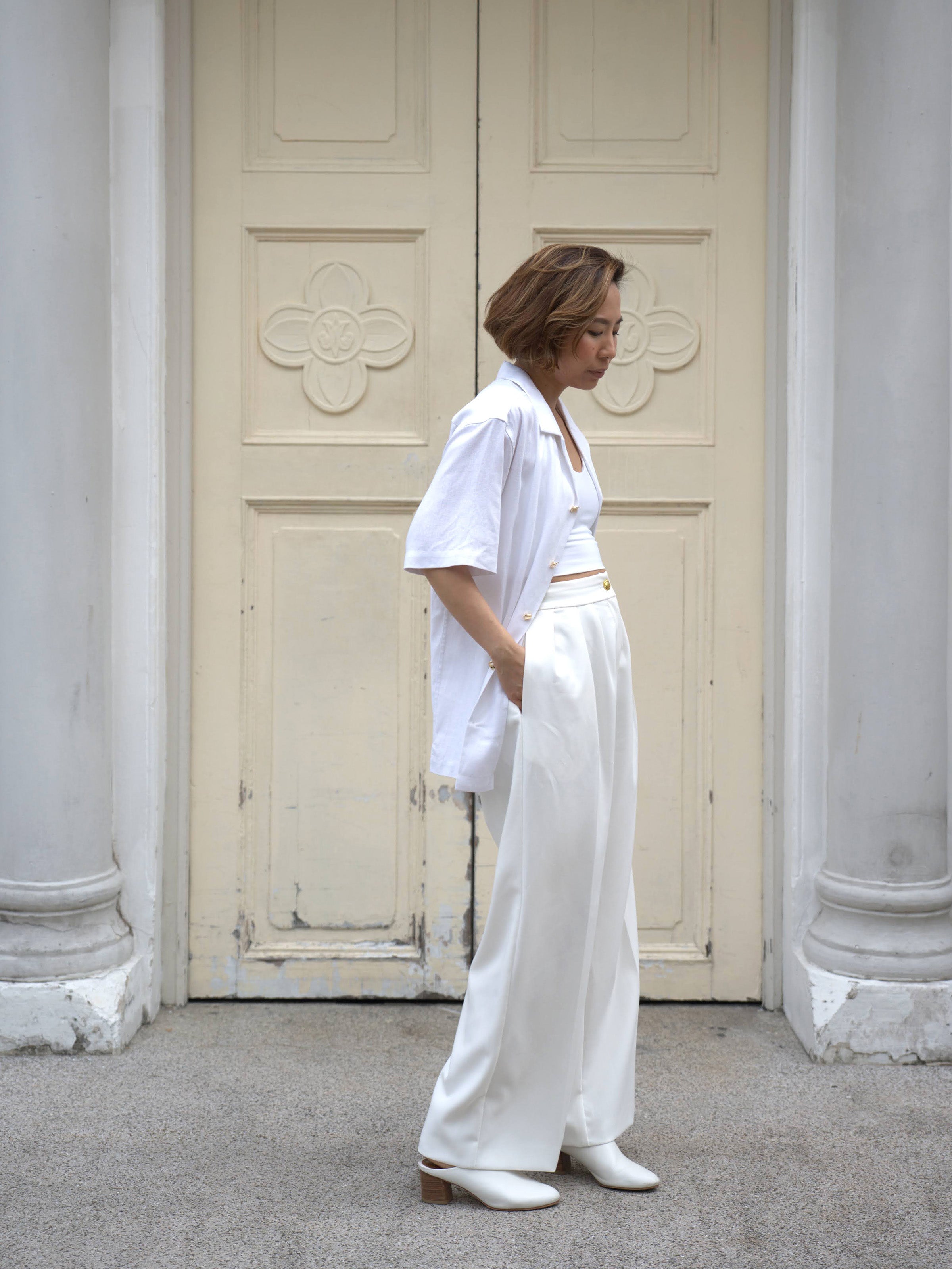 Woman wearing white linen top and white skirt by Singapore women's fashion brand Hadasity.