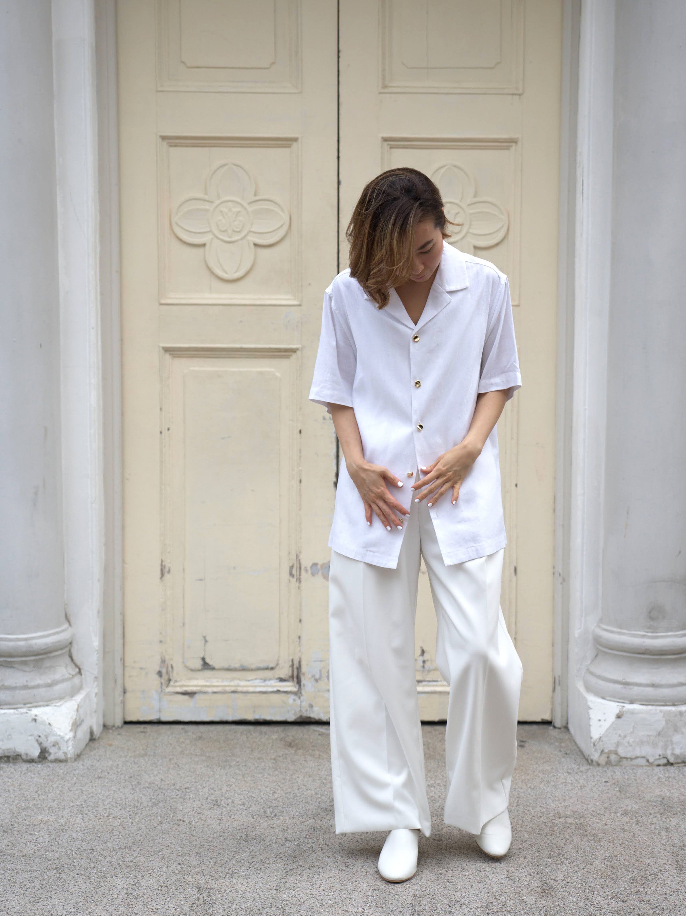 Woman wearing white linen top and white skirt by Singapore women's fashion brand Hadasity.