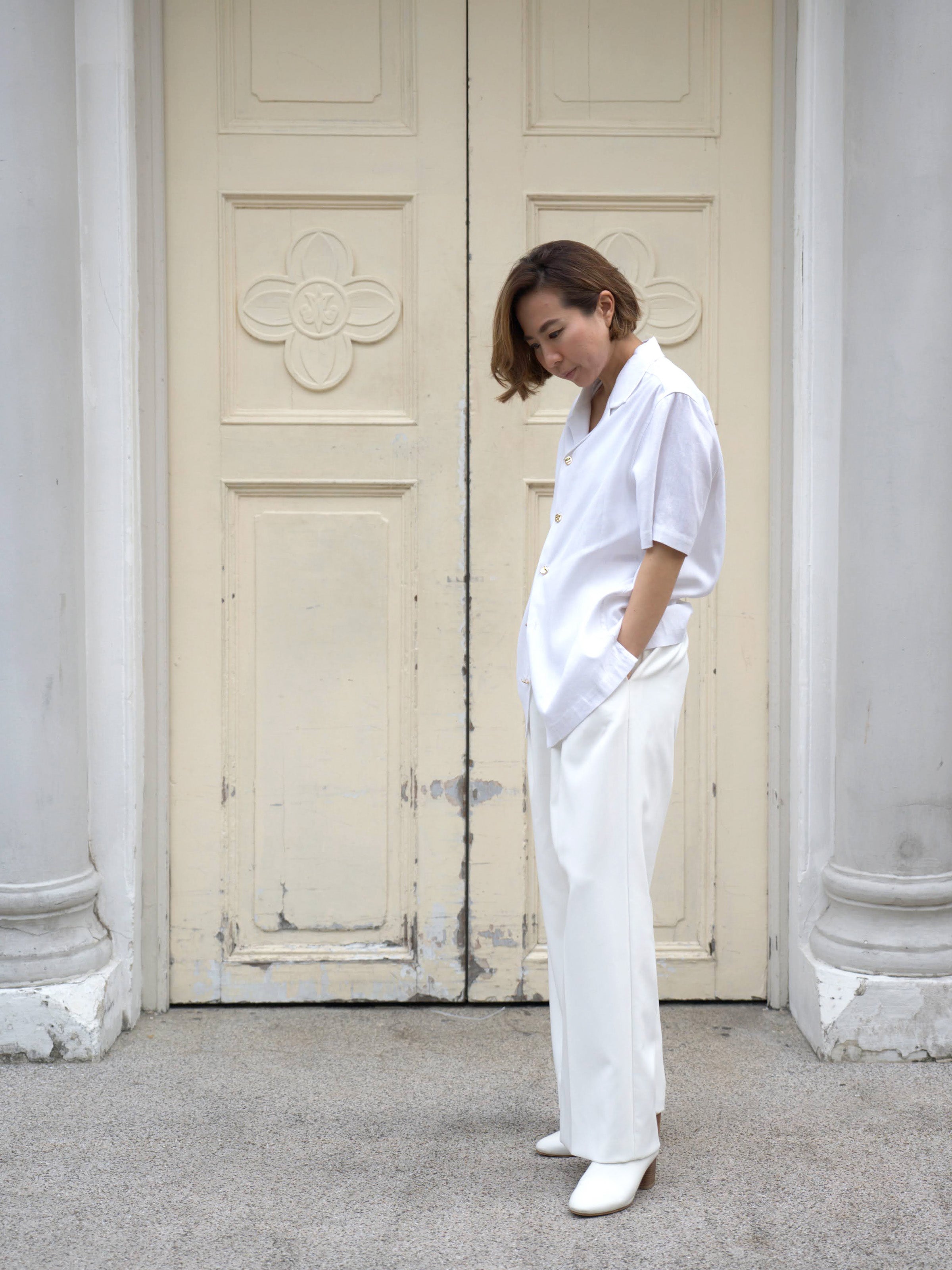 Woman wearing white linen top and white skirt by Singapore women's fashion brand Hadasity.