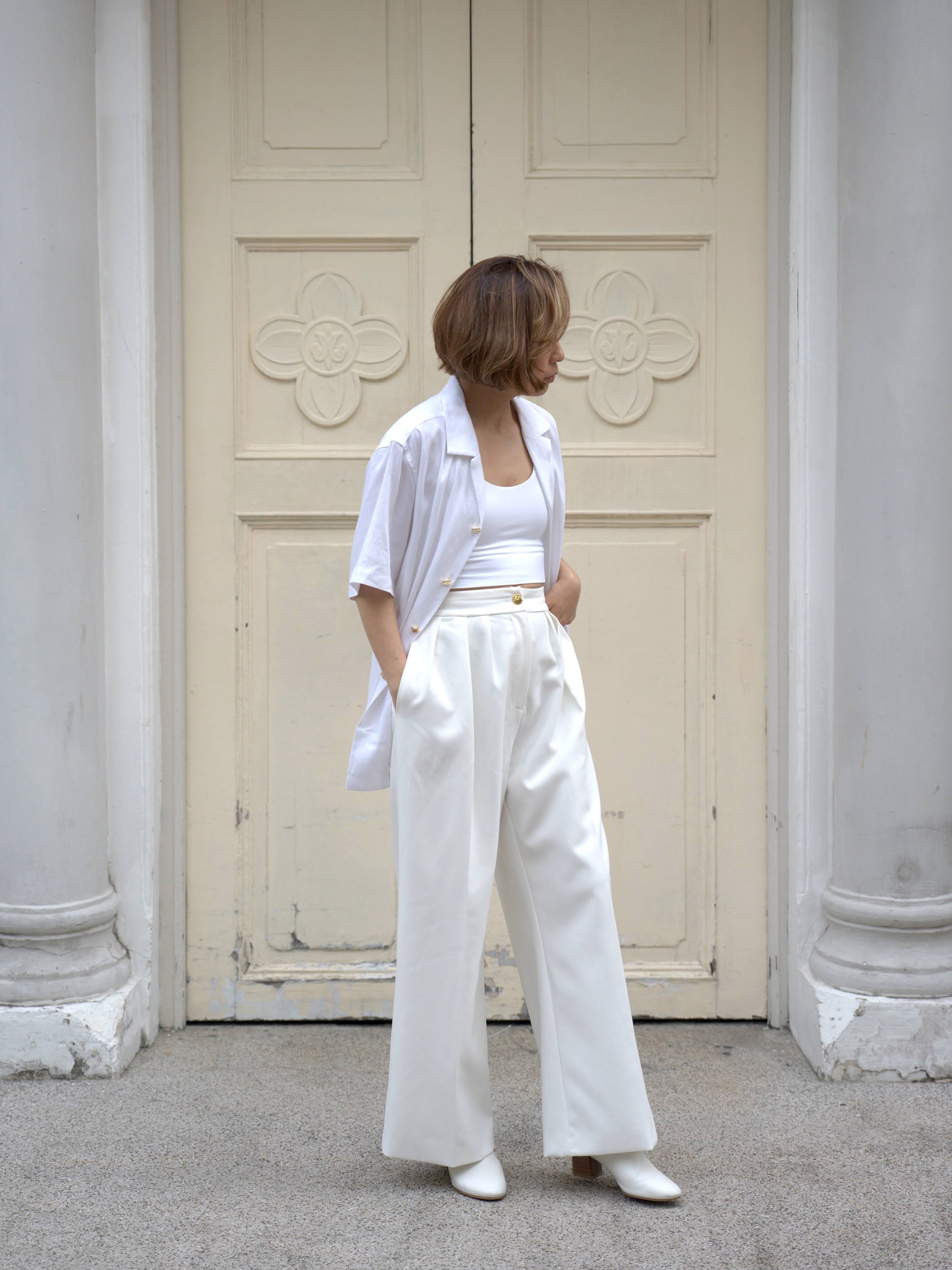 Woman wearing white linen top and white skirt by Singapore women's fashion brand Hadasity.
