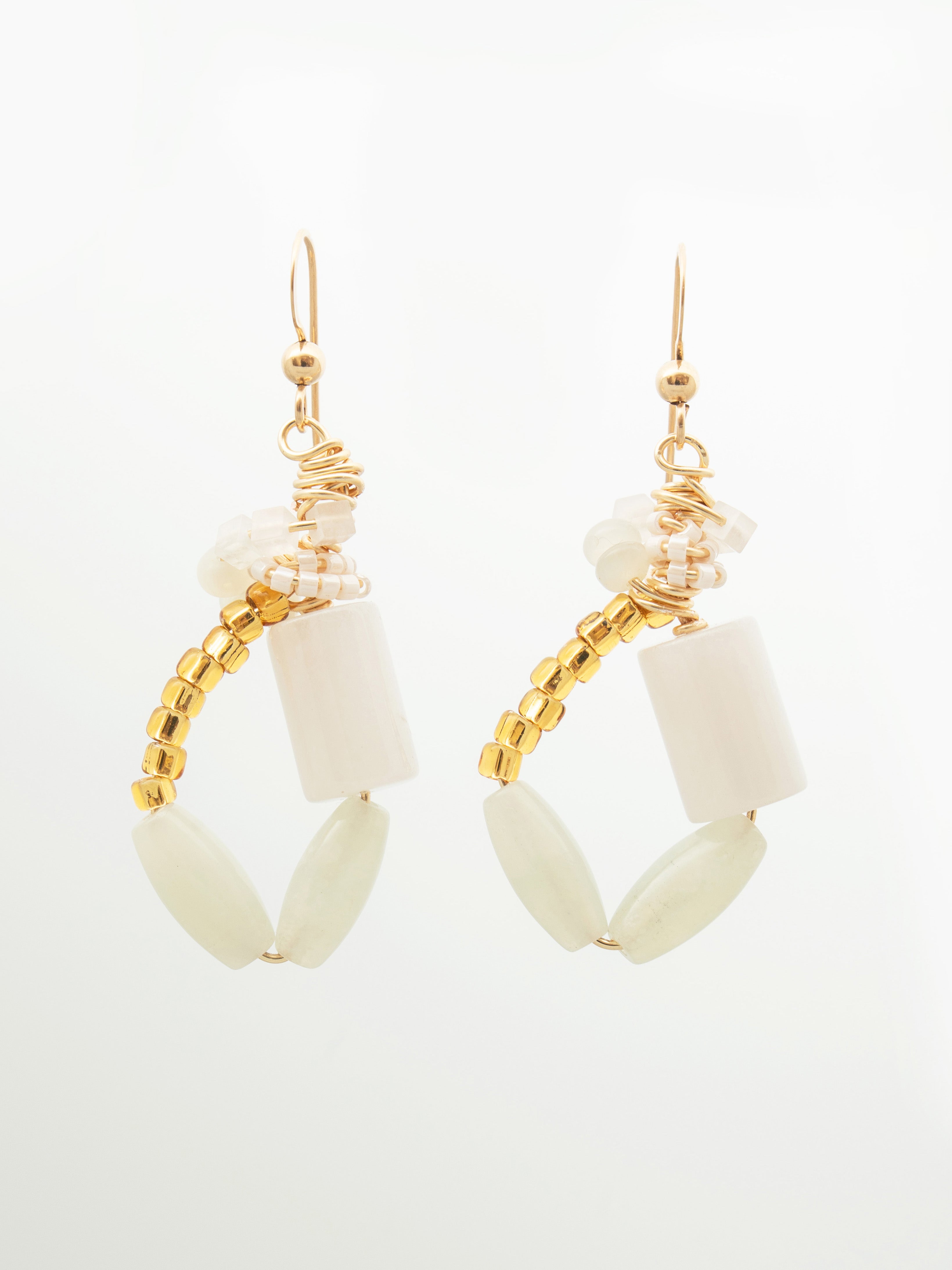 Pair of earrings with white cylindrical beads, pale green beads, and gold white seed beads