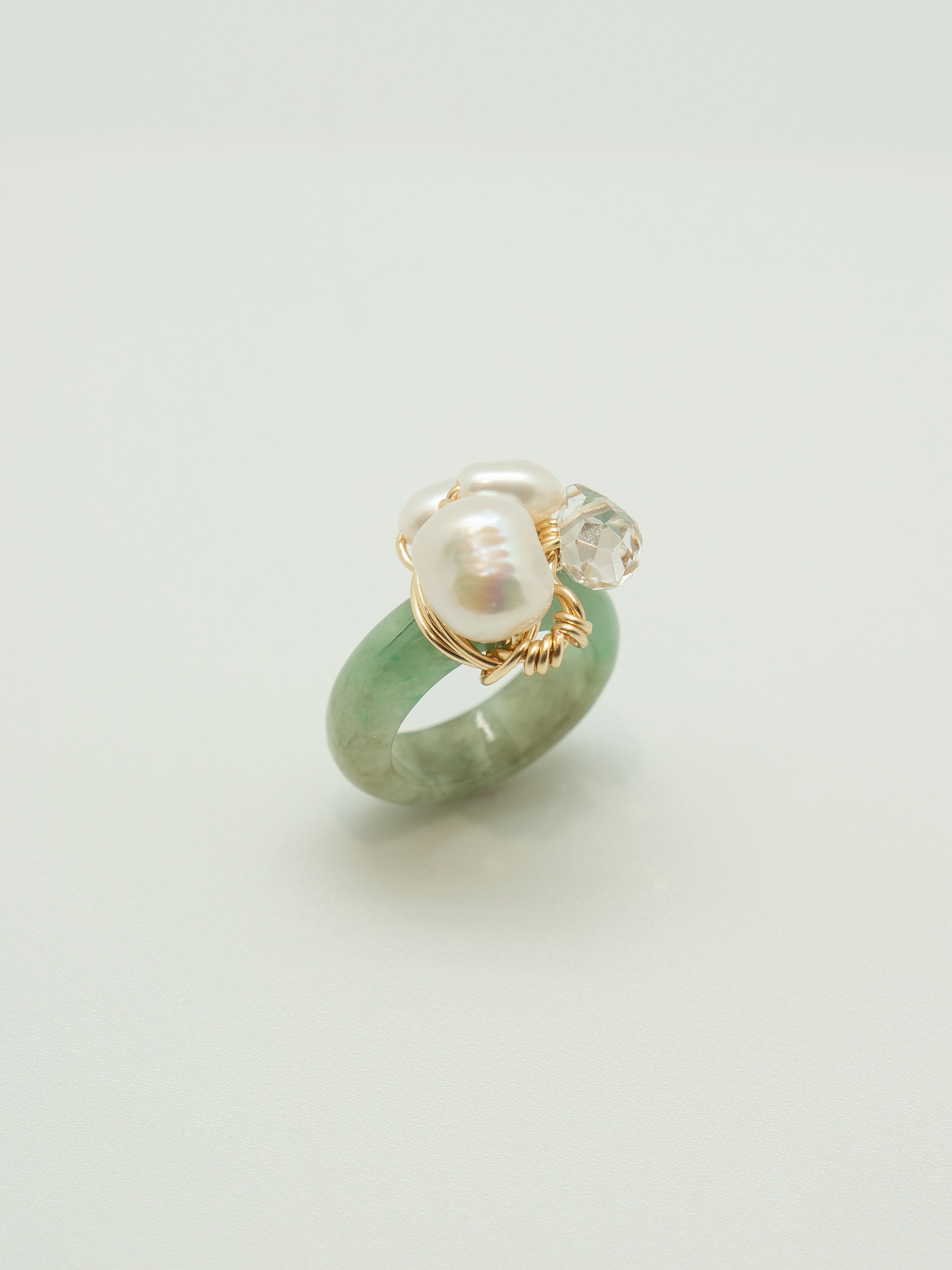 One of a kind jade ring with a trio of pearls and clear crystal.