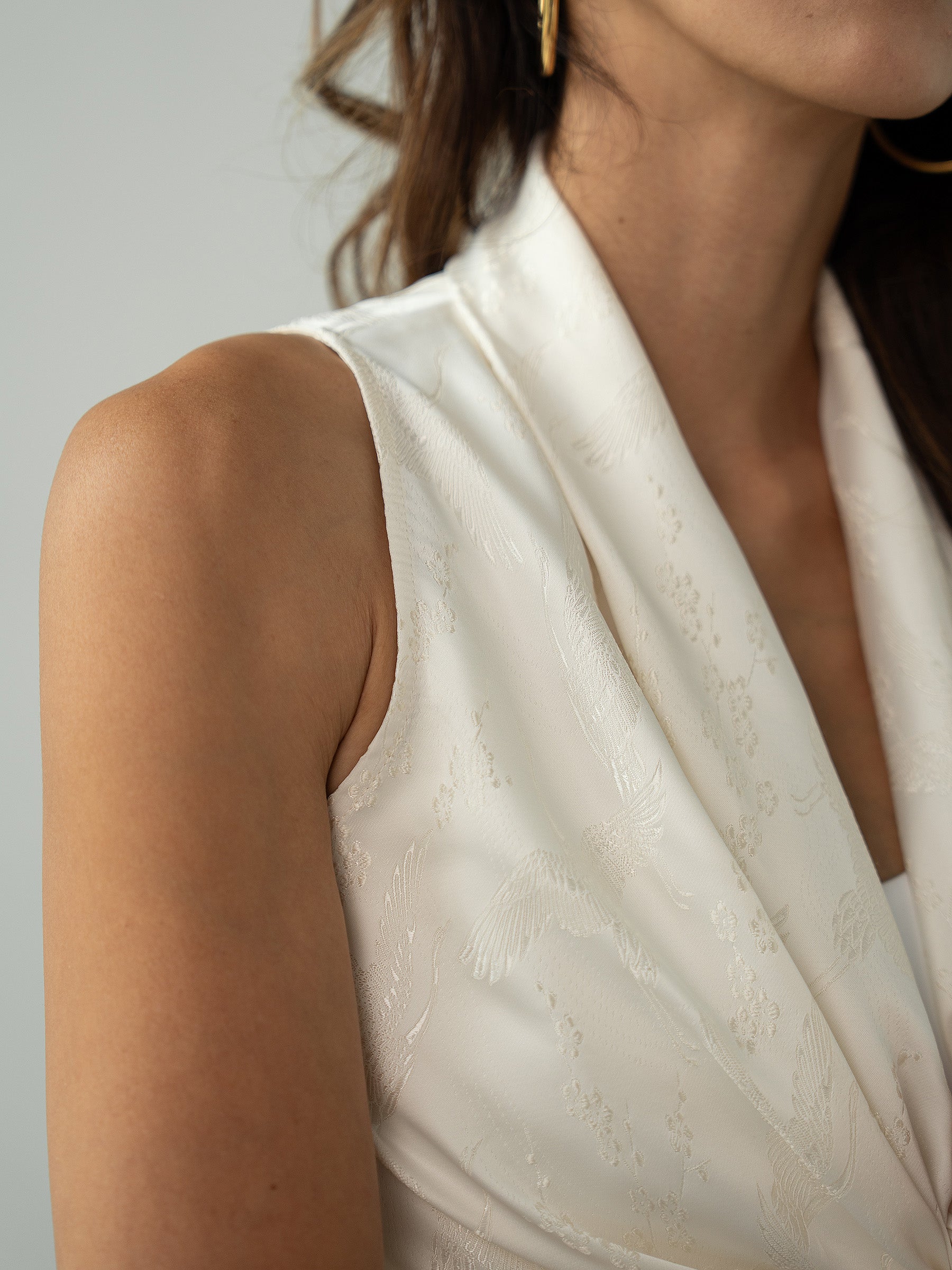 Woman wearing white sleeveless wrapped multi-way top by Singapore women's fashion brand Hadasity.
