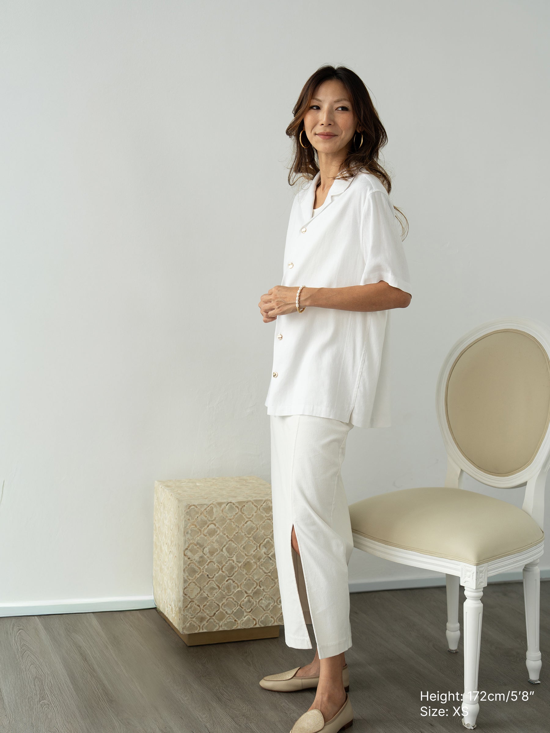 Woman wearing white linen top and white skirt by Singapore women's fashion brand Hadasity.