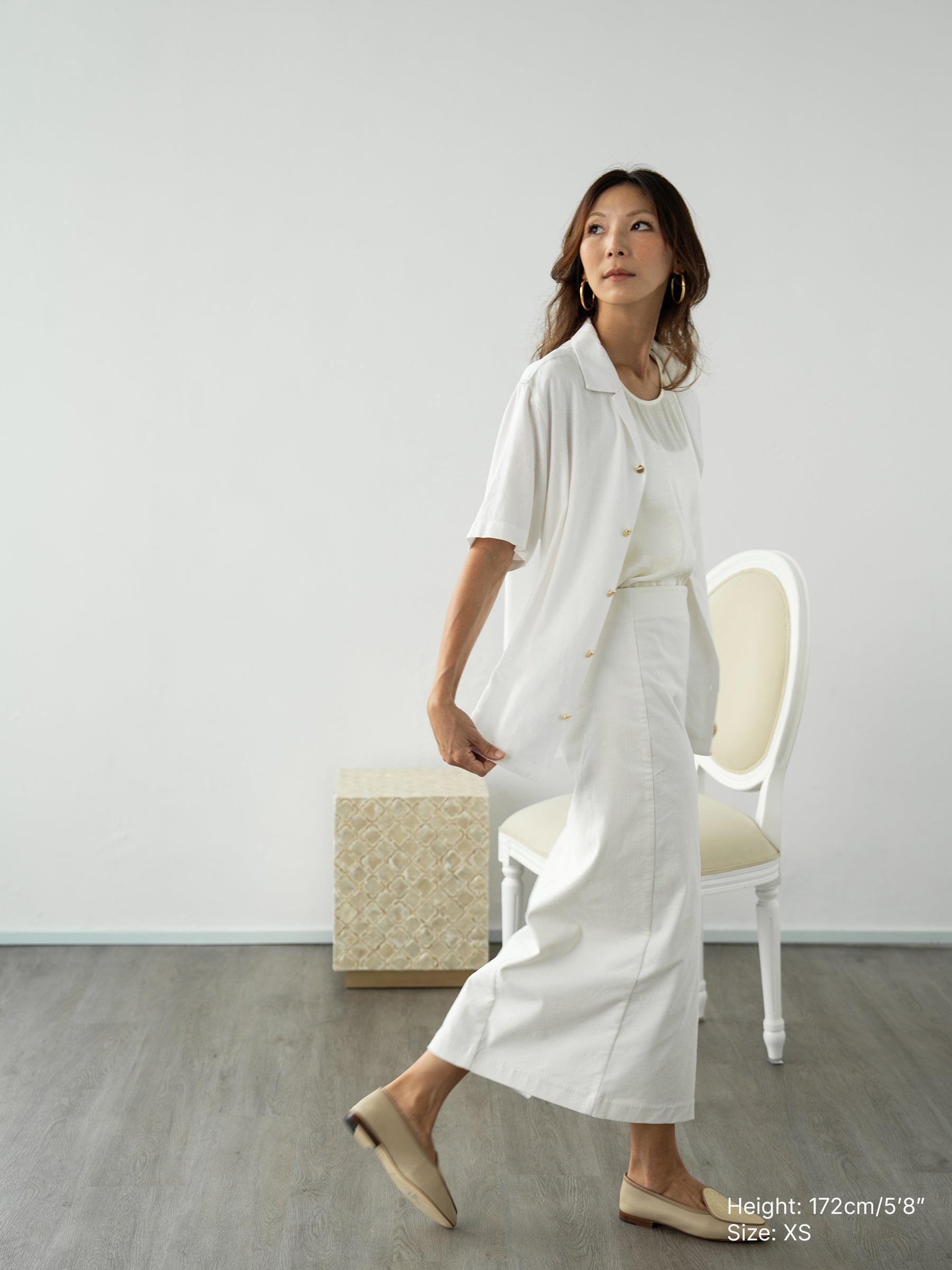 Woman wearing white linen top and white skirt by Singapore women's fashion brand Hadasity.