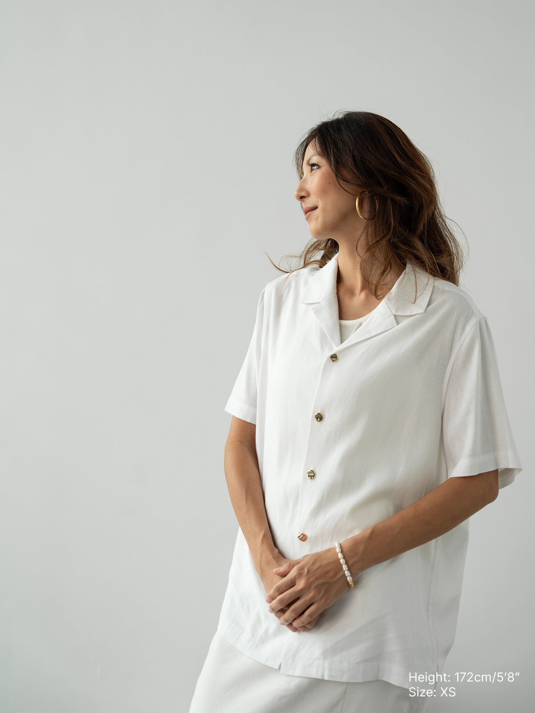 Woman wearing white linen top and white skirt by Singapore women's fashion brand Hadasity.