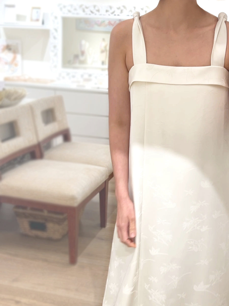 Woman wearing white sleeveless maxi dress by Singapore women's fashion brand Hadasity.